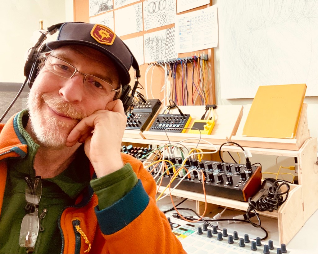 Gregory Scheckler in his studio with synthesizers